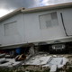 A car is crushed under a home that collapsed after the previous day’s magnitude 6.4 earthquake in Yauco, Puerto Rico, Jan. 8, 2020. More than 250,000 Puerto Ricans remained without water on Wednesday and another half a million without power, which also affected telecommunications.
